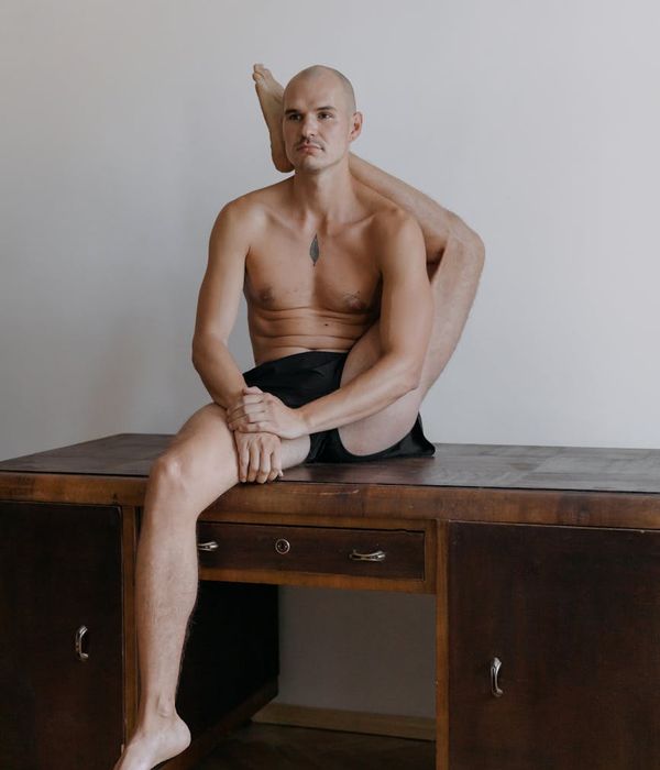 Man performing a controlled strength exercise in a minimalist setting.